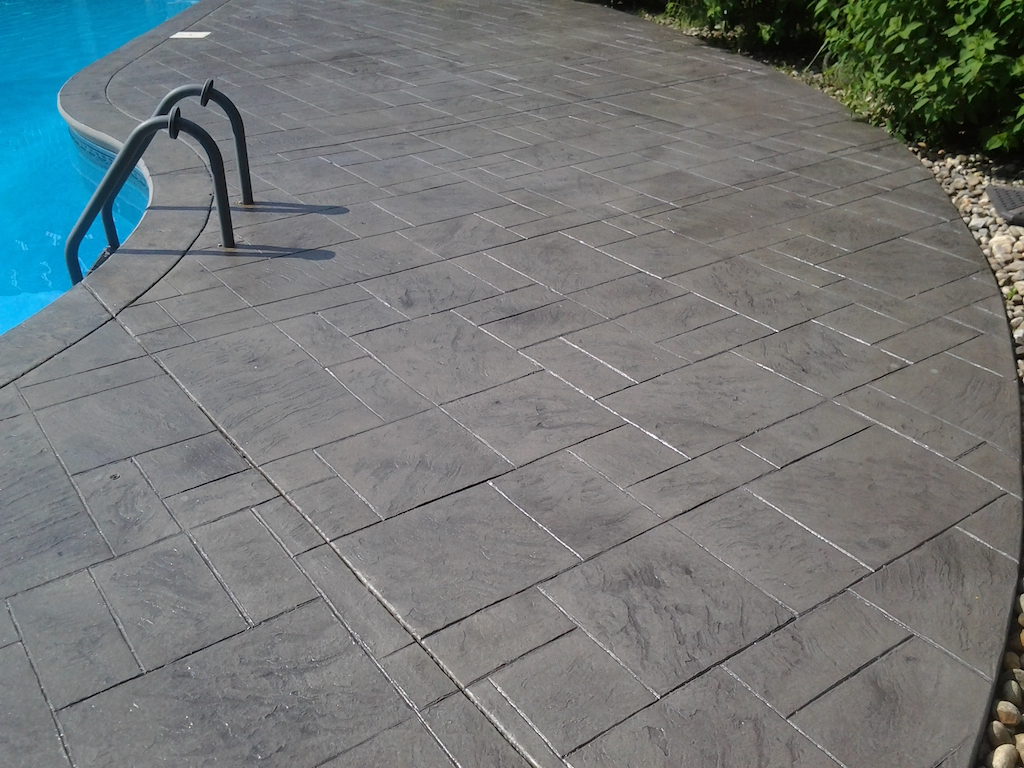 Interlocking paver installation shaping a residential patio or driveway